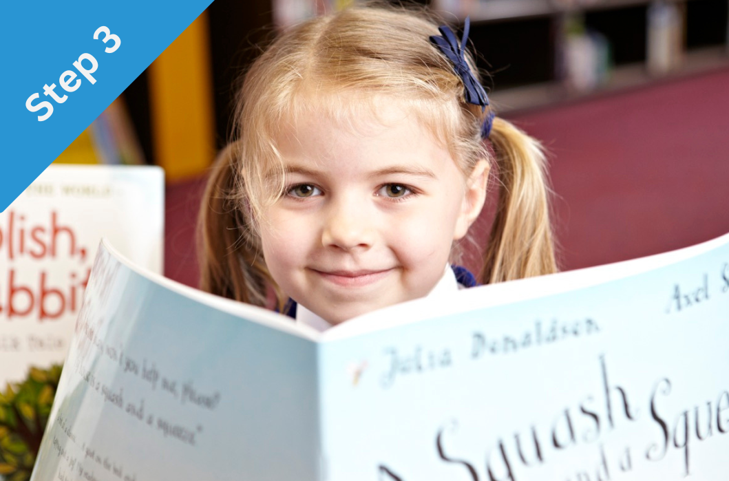 A female student with a KS1 reading book